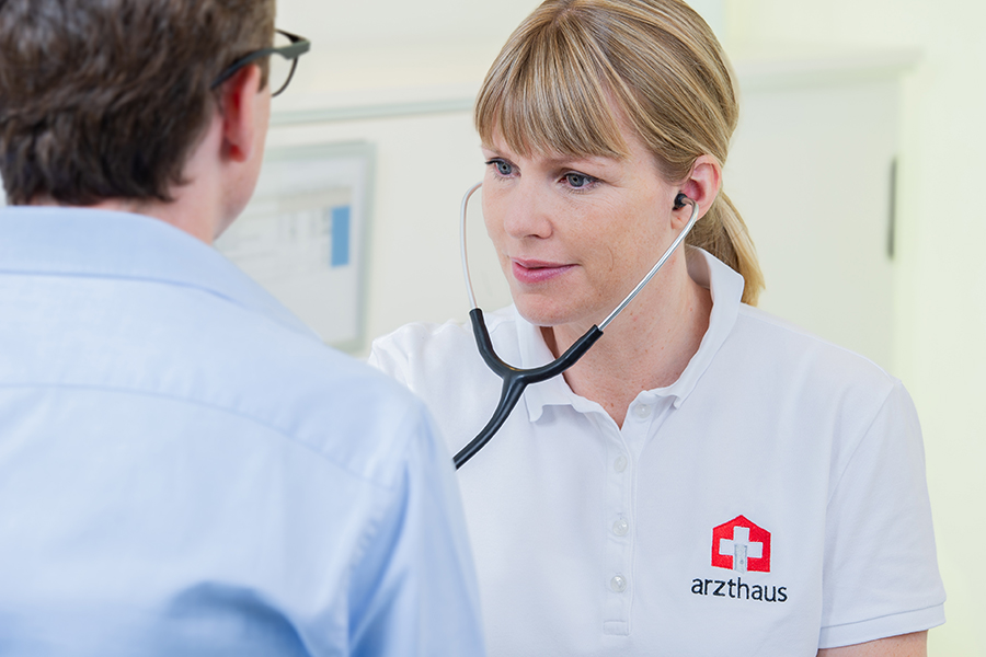 Doctor listening to patient's chest with stethoscope