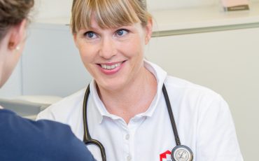 Doctor talking to patient in the doctor's office